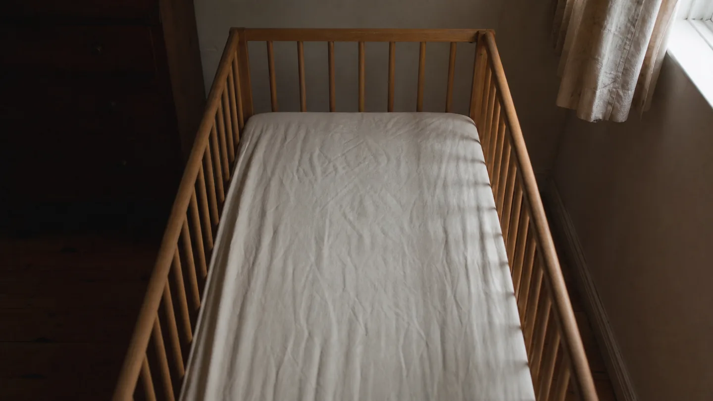 cot with a fitted sheet and nothing else