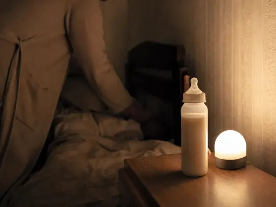 dark bedroom, bottle on a nightstand