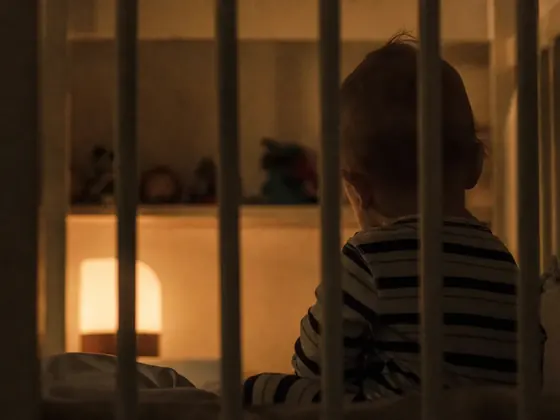 cot bars, dim room, early evening