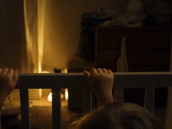 cot with a standing baby, night light