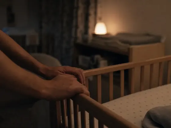cot side, hands, dim nursery
