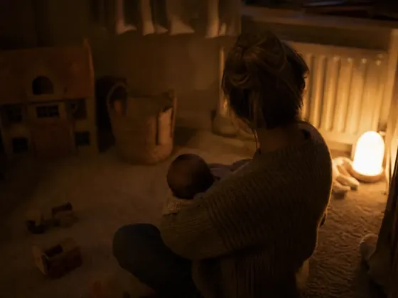 dark room, toys on the floor, one lamp