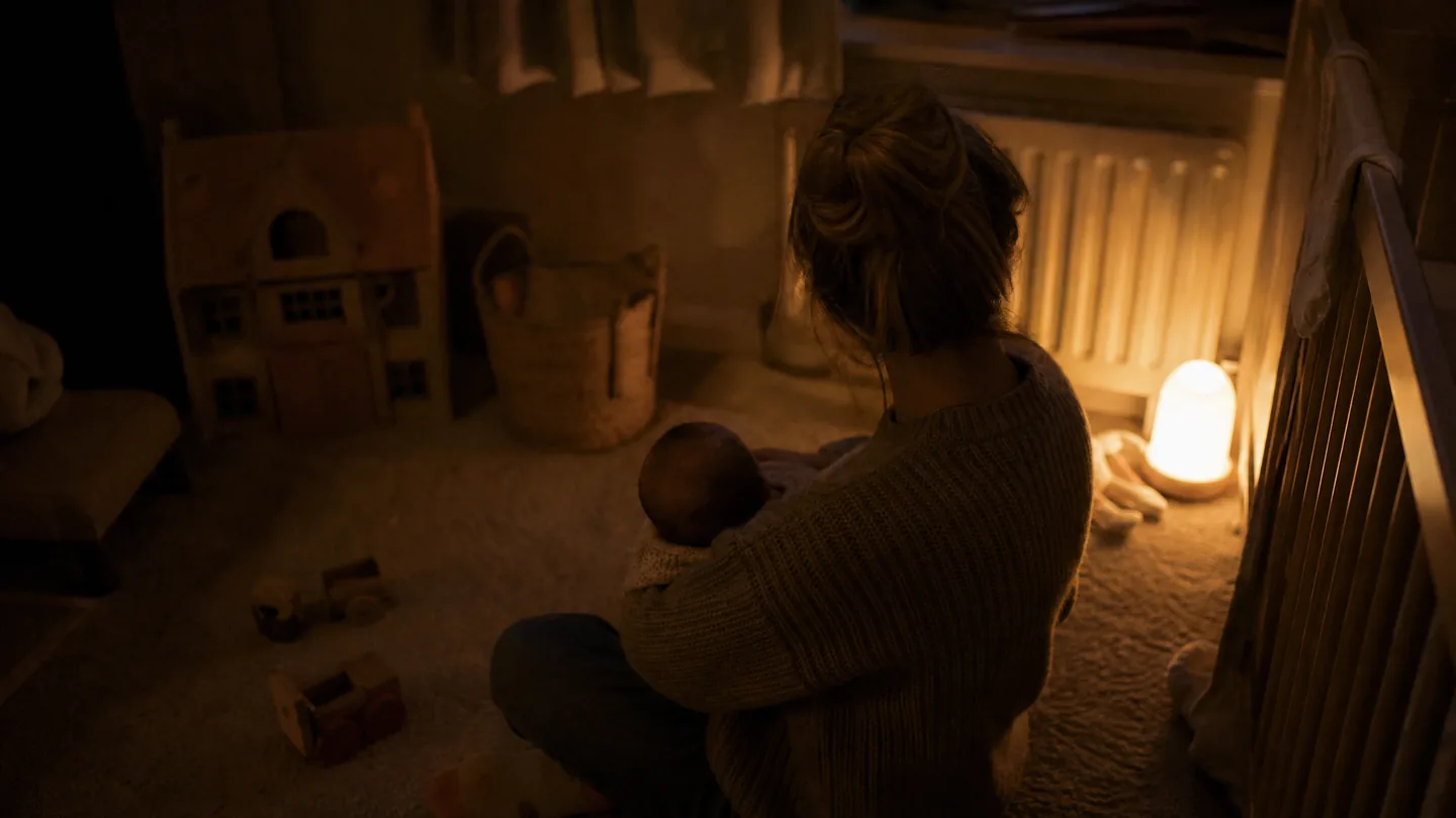dark room, toys on the floor, one lamp